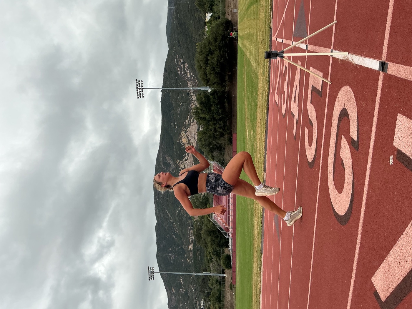 An athlete mid-stride alongside an EqualSplit timing gate on the track