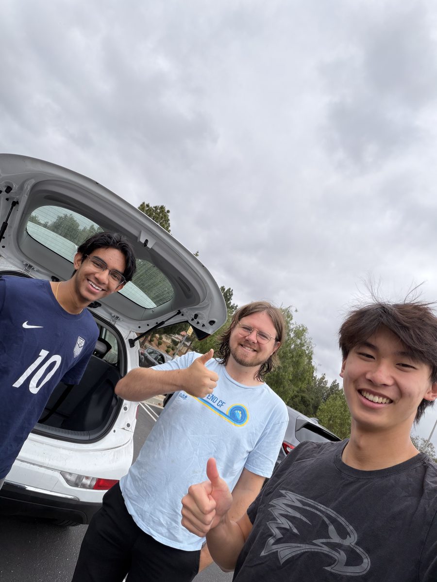 Louis, Mr. Lippincott, and Jayden in a school parking lot